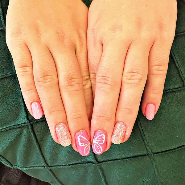 Pink nails with white butterfly art by Sandy Hill Spa