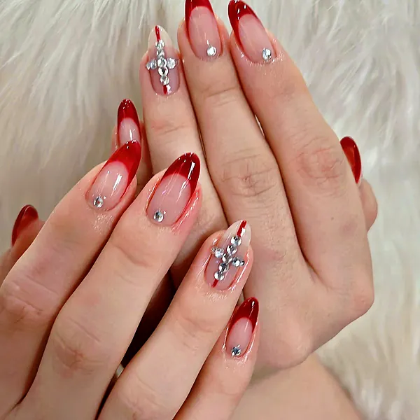Red French tips with crystal charms by Sandy Hill Spa